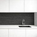 Modern kitchen with white cabinets, charcoal line stone flexible stone backsplash, and silver faucet.