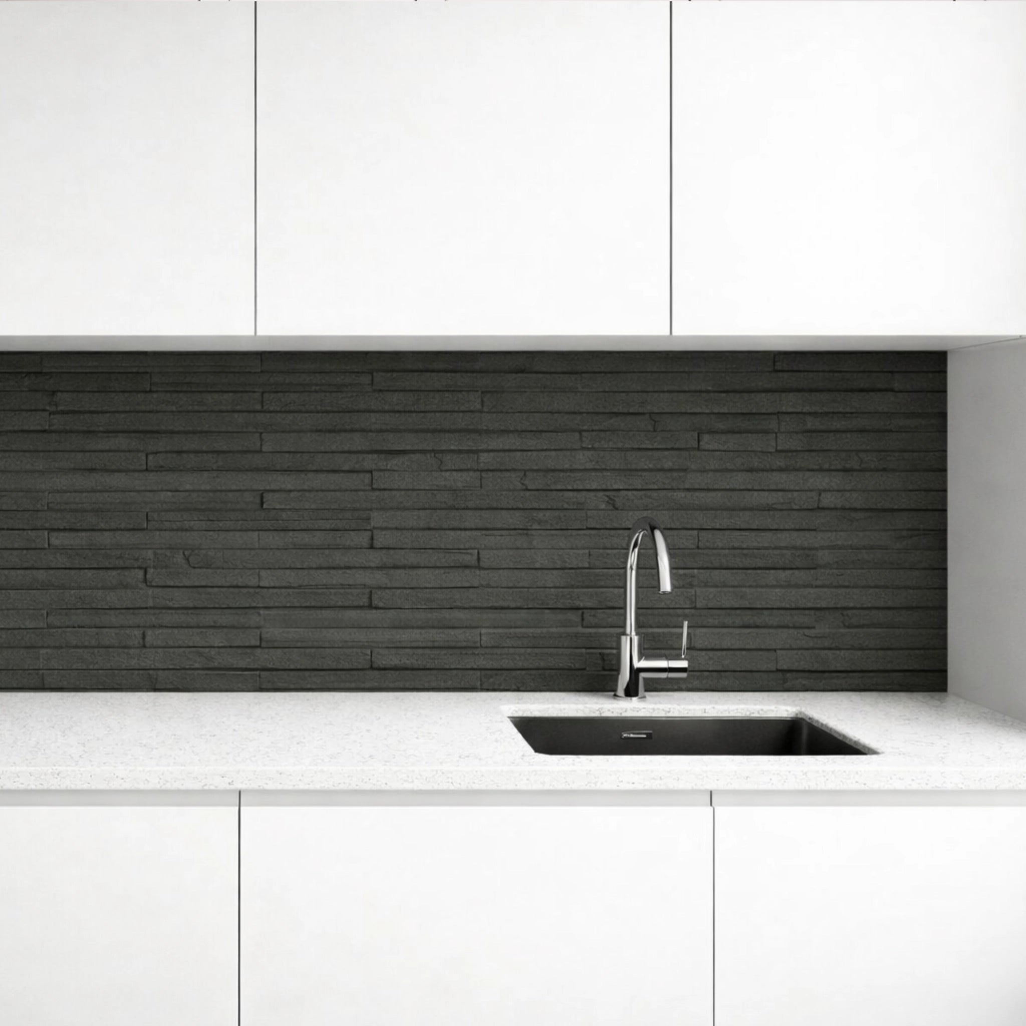 Modern kitchen with white cabinets, charcoal line stone flexible stone backsplash, and silver faucet.
