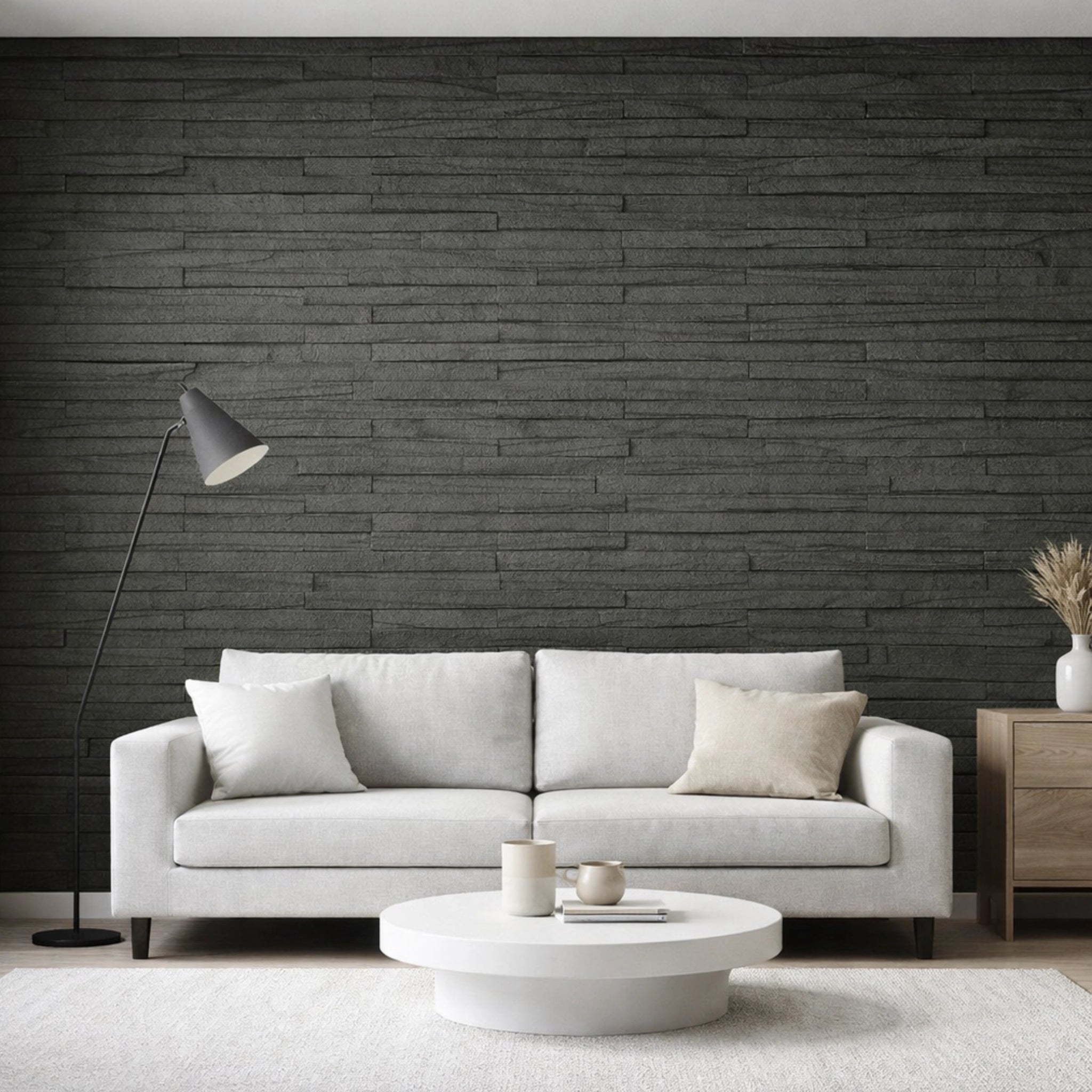 Modern living room with a gray sofa, coffee table, and decorative items against a charcoal line stone flexistone wall