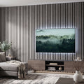 Living room with a large TV displaying a nature scene, concrete grey acoustic wall panelled wall, and gray sofa.