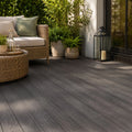 premium dual-capped charcoal composite decking in a garden setting with garden furnishings