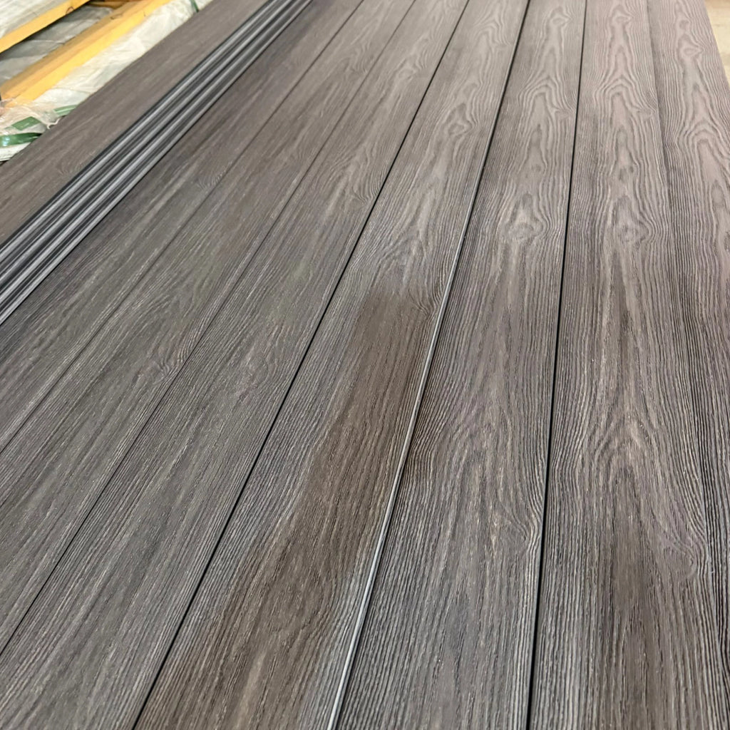 premium dual-capped charcoal composite decking boards on a pallet