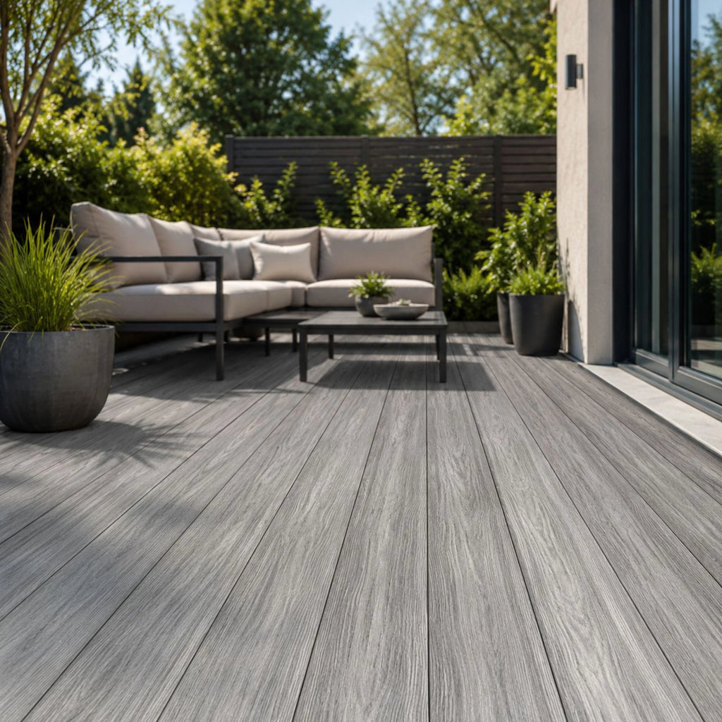 grey premium dual-capped composite decking boards in a garden setting 