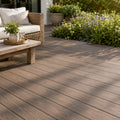 premium dual capped elm composite decking boards in a garden setting