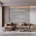 Modern living room with a beige sectional sofa, coffee table, and decorative items against a flexistone grey travertine peel and stick wall