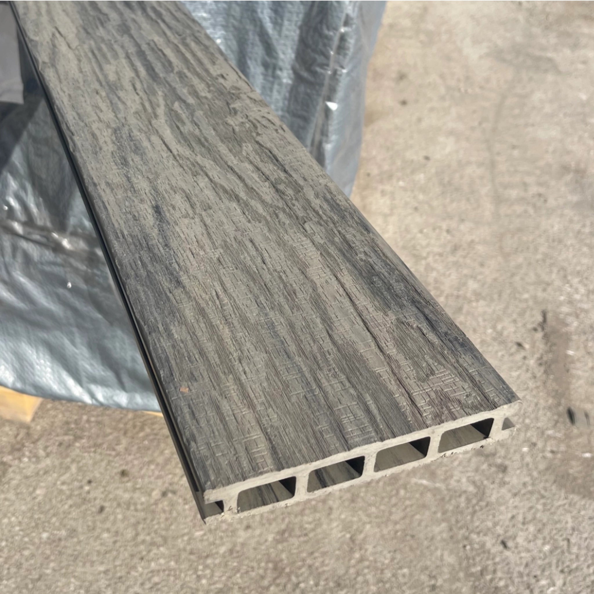 composite deck board with a textured surface on a concrete floor