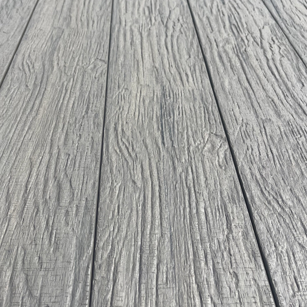 Close-up of gray composite decking planks with a textured surface