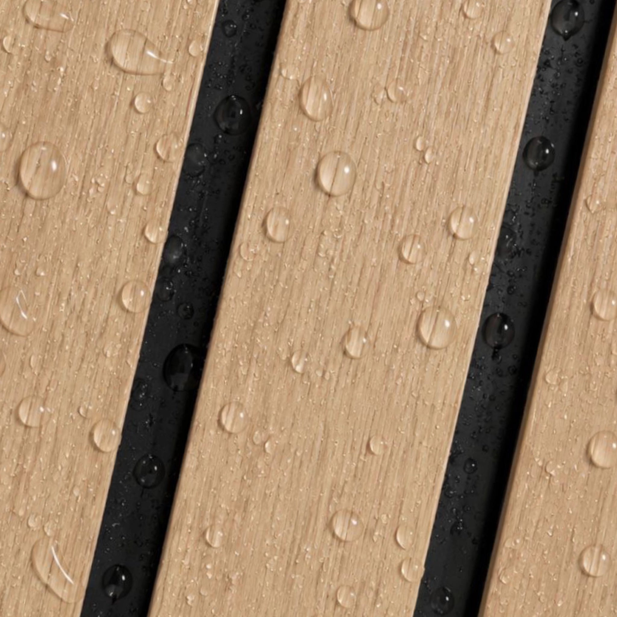 Close-up of a wood-look surface with diagonal planks in light tan and black, covered with water droplets.