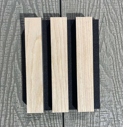 Wooden slats with black separators on a textured gray background