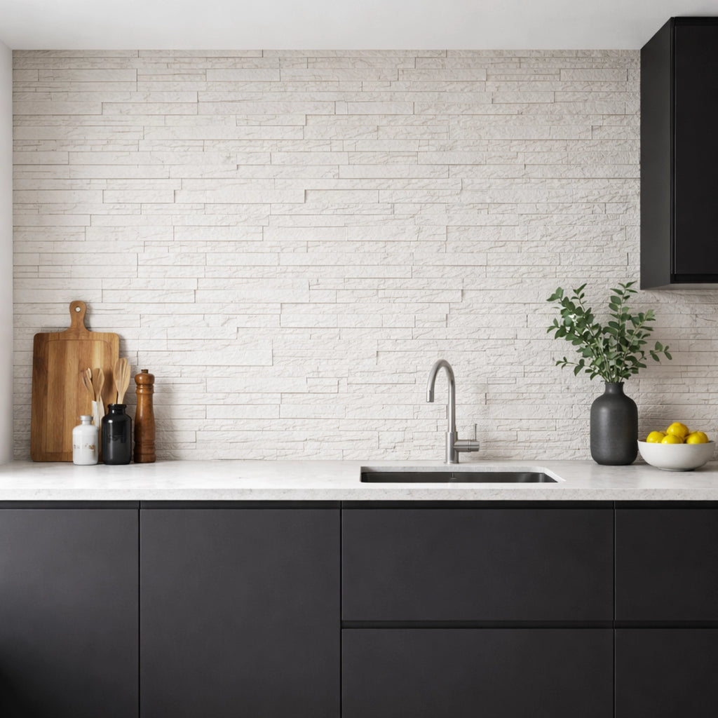 Modern kitchen with black cabinets, white countertop, and off white flexistone style brick wall.