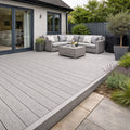 Outdoor patio with salt lake silver deck, sectional sofa, and potted plants.
