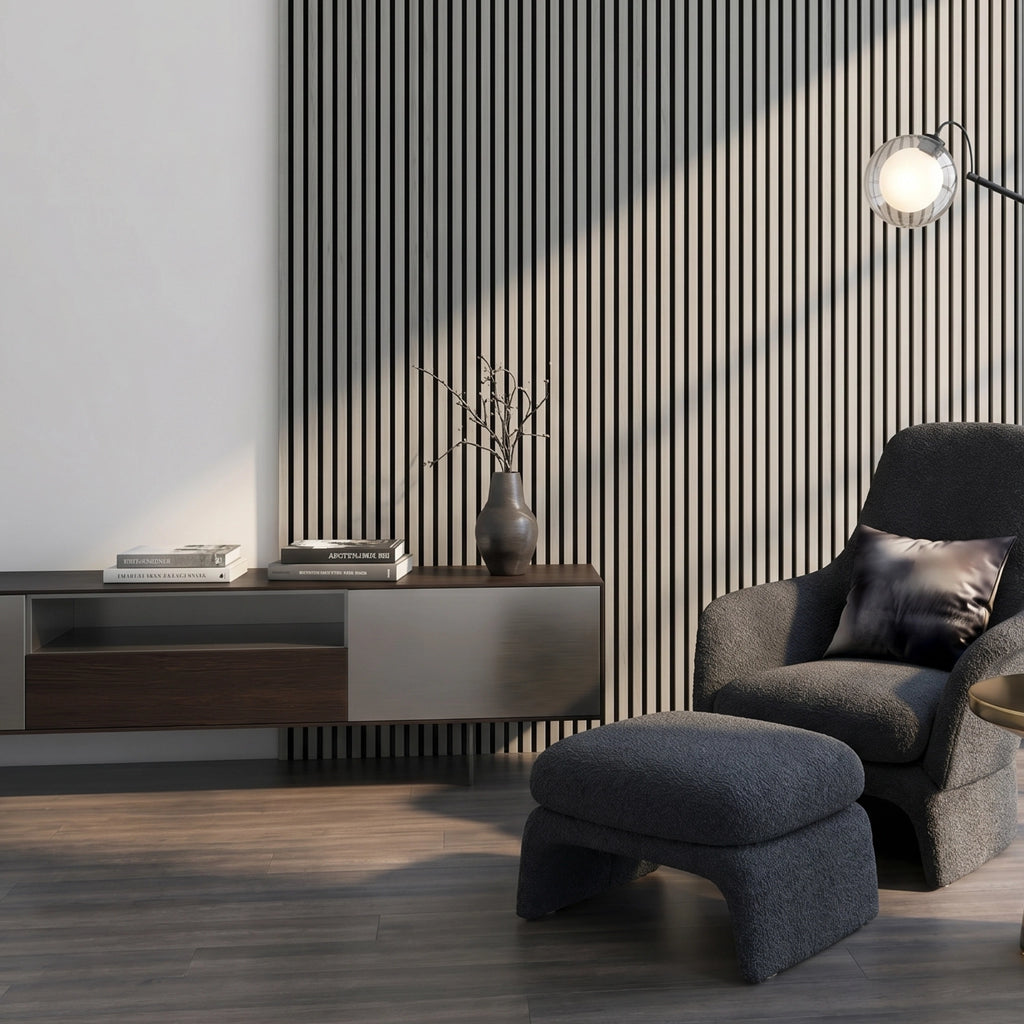 Modern living room with a gray armchair and ottoman against a silver oak acoustic wall panelled wall.