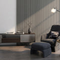 Modern living room with a gray armchair and ottoman against a silver oak acoustic wall panelled wall.