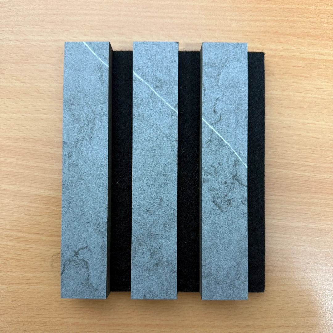 Three rectangular stone slabs with a blue and gray pattern on a wooden surface
