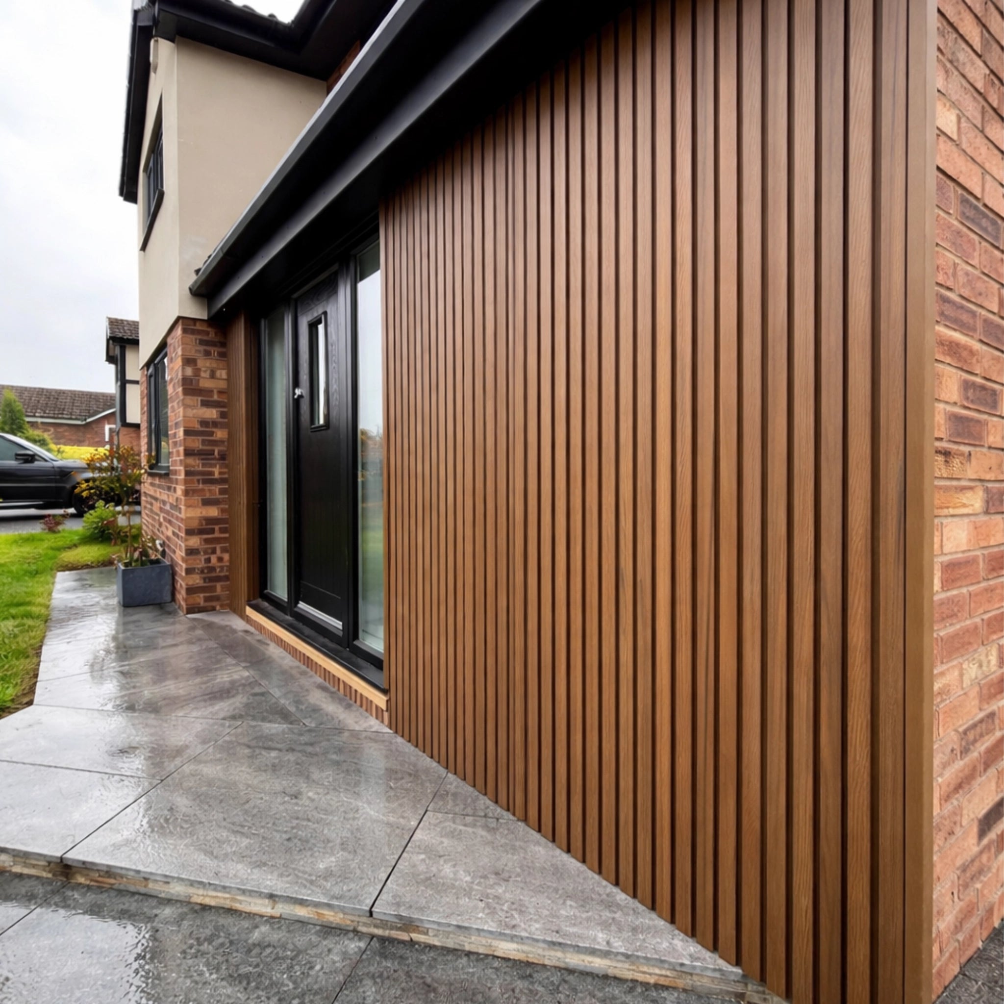 Modern house exterior with teak co-extrusion composite cladding and brickwork