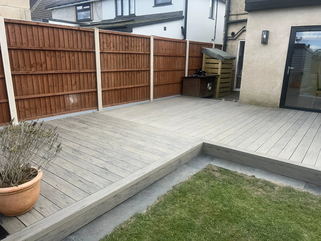 grey driftwood decking in a garden setting with lawn