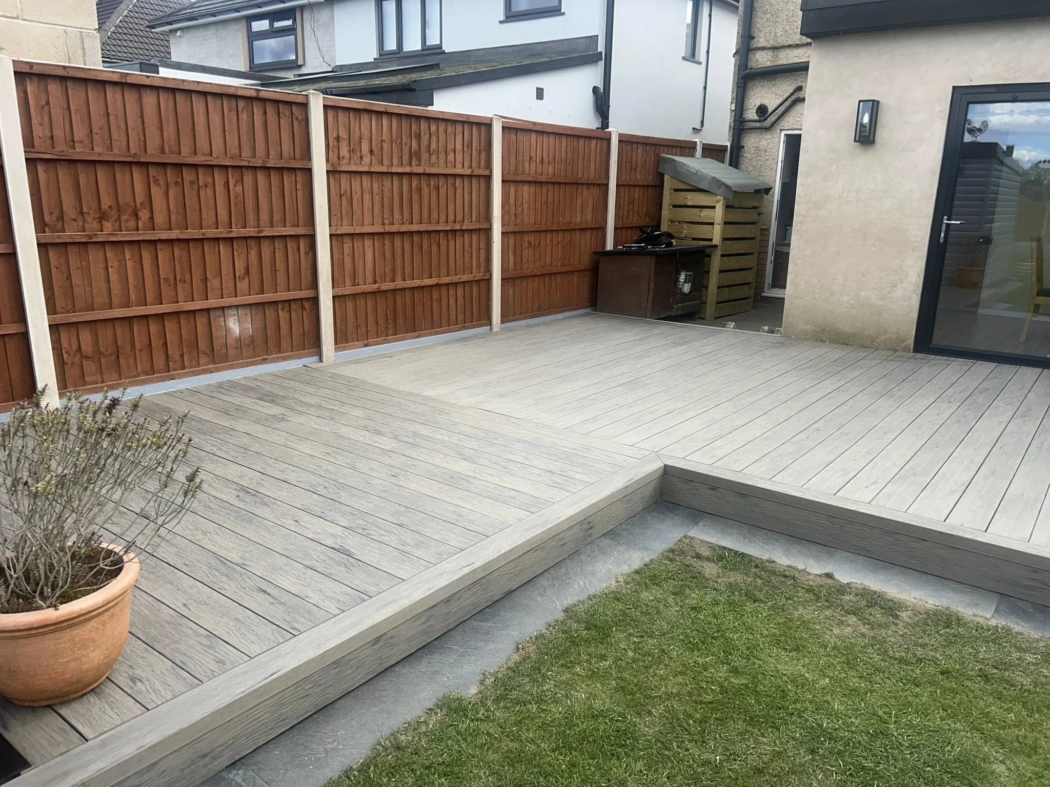 grey driftwood decking in a garden setting with lawn